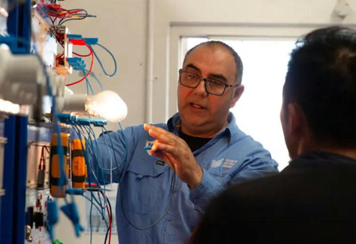 Electrician studying wiring diagrams with tools